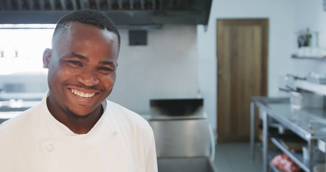 Smiling African Chef in Modern Commercial Kitchen - Free Images, Stock Photos and Pictures on Pikwizard.com