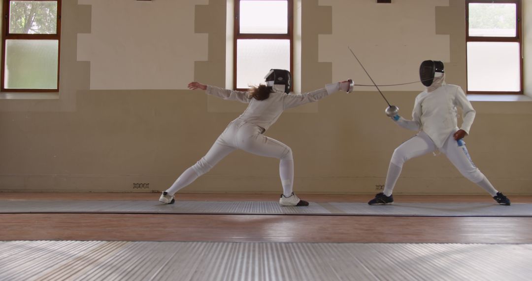 Two Athletes Fencing in Training Hall - Free Images, Stock Photos and Pictures on Pikwizard.com