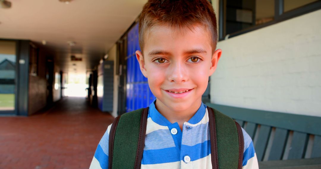 Smiling Schoolboy Standing in Corridor