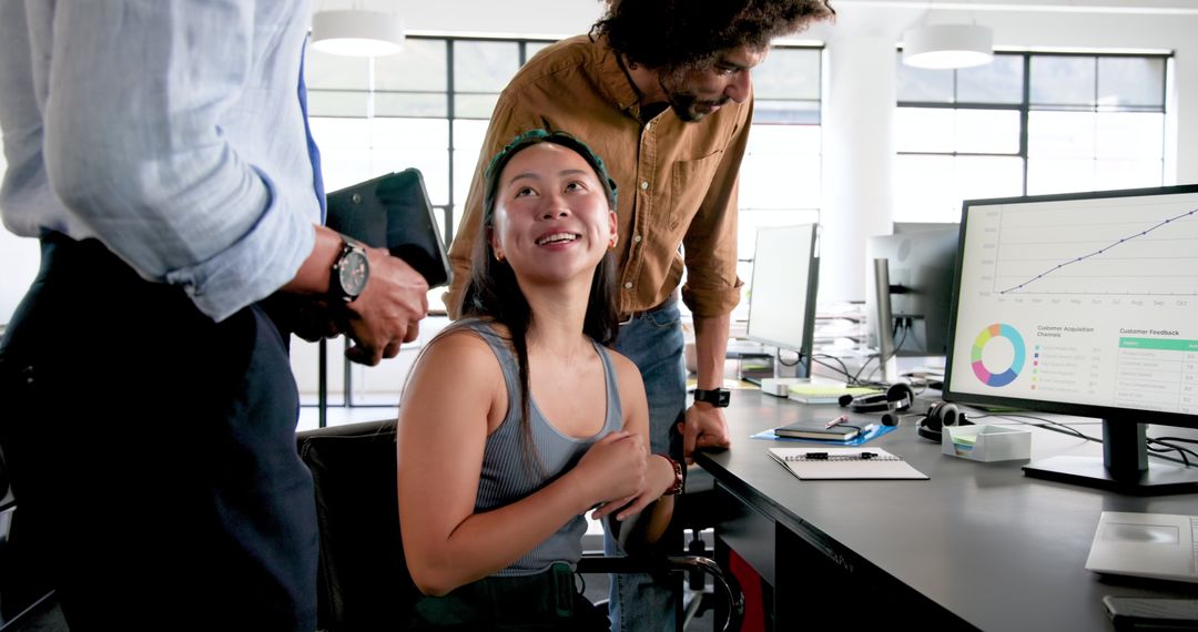 Happy Colleagues Collaborating Around Office Computer