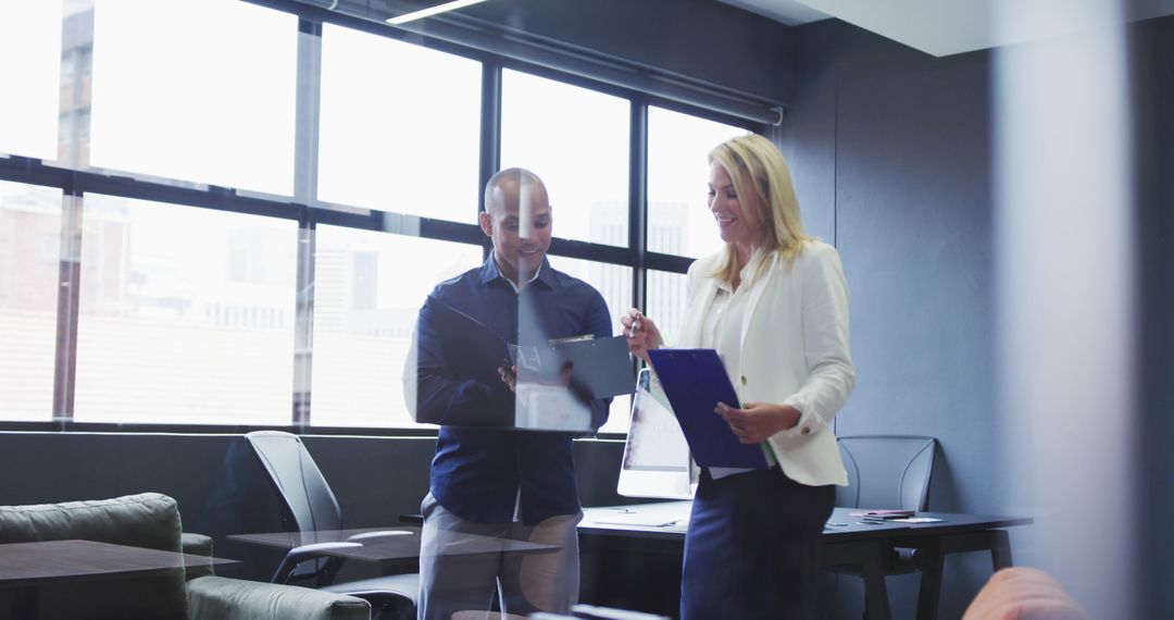 Diverse Colleagues Discussing Documents in Modern Office Setting