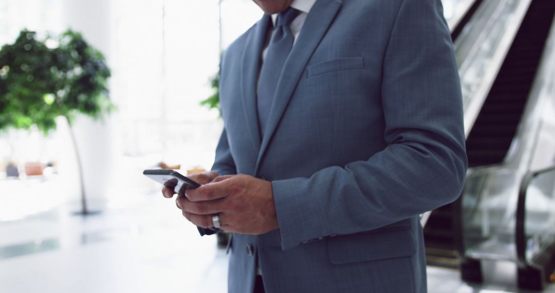 Business Professional Texting in Office Building - Free Images, Stock Photos and Pictures on Pikwizard.com