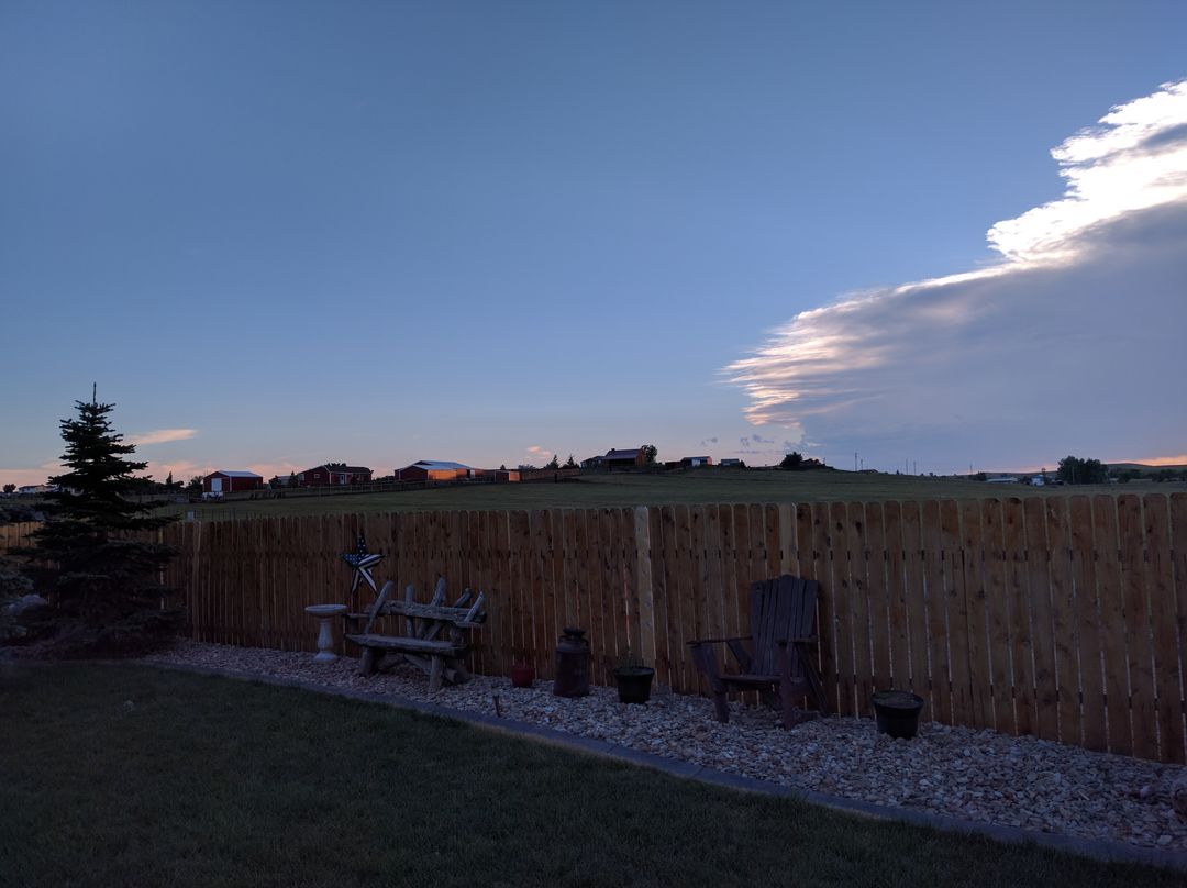 Scenic Suburban Backyard with Wooden Fence at Sunset - Free Images, Stock Photos and Pictures on Pikwizard.com