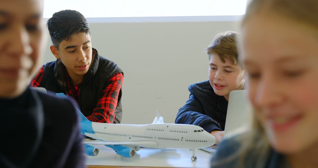 Teen Students Collaborating in Hands-on Aviation Workshop - Free Images, Stock Photos and Pictures on Pikwizard.com