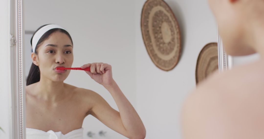 Woman Brushing Teeth in Front of Mirror at Home - Free Images, Stock Photos and Pictures on Pikwizard.com