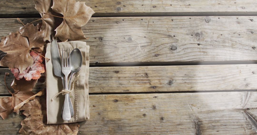 Autumn Cutlery Display on Rustic Wooden Background