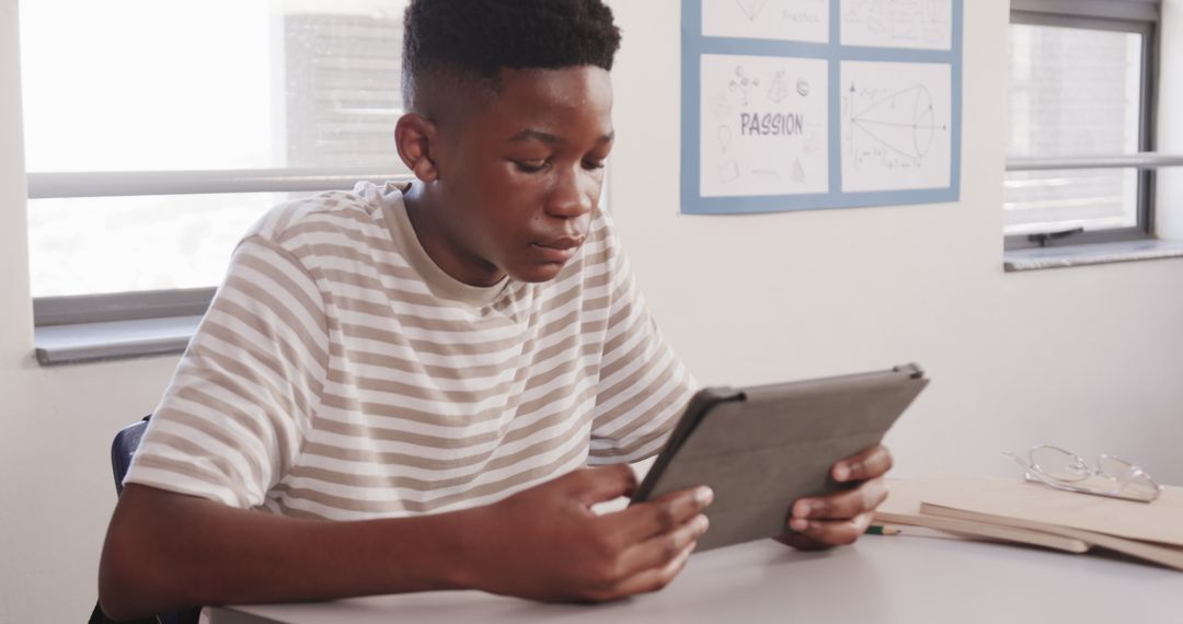 Focused Teenager Engaging in Digital Learning with Tablet in Classroom