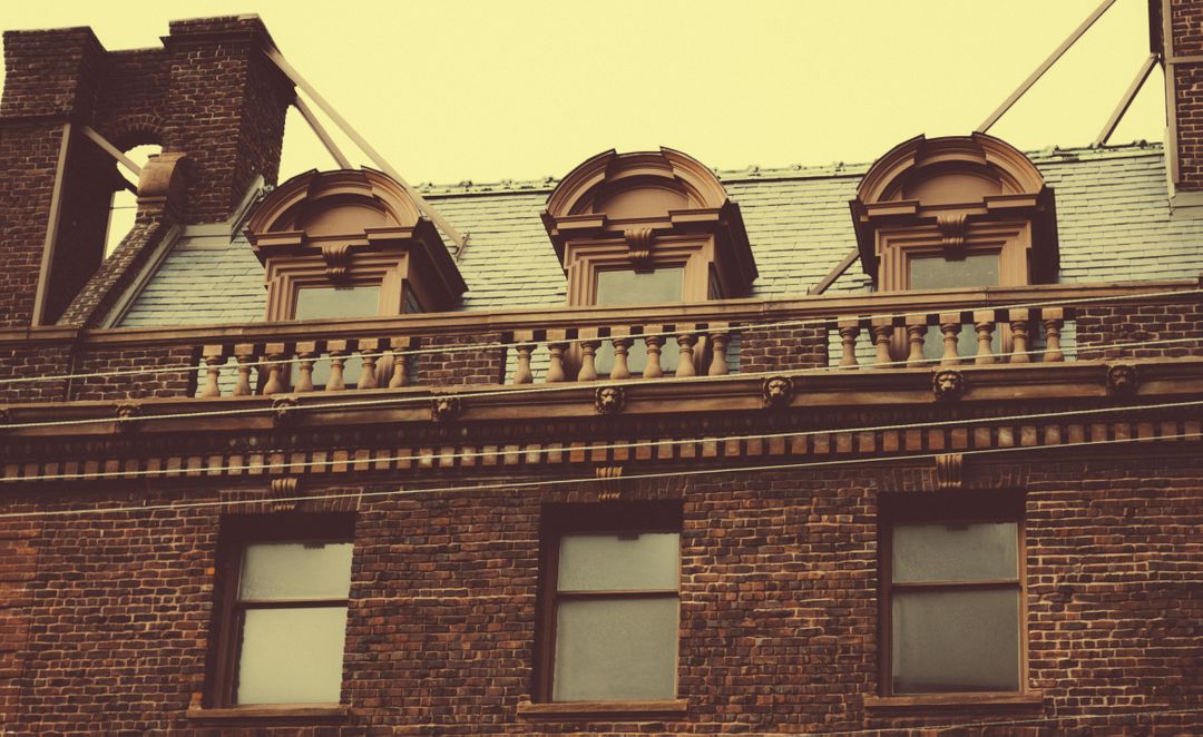 Vintage Façade of Historic Brick Building with Unique Windows - Free Images, Stock Photos and Pictures on Pikwizard.com