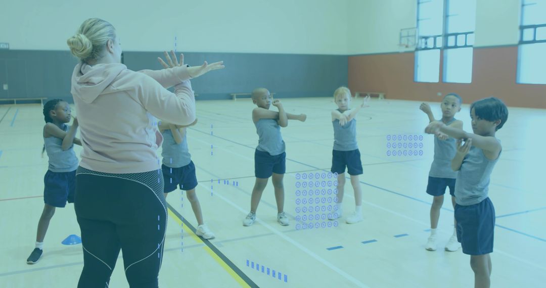 School PE instructor leading dynamic warm-up stretches with children in bright gymnasium