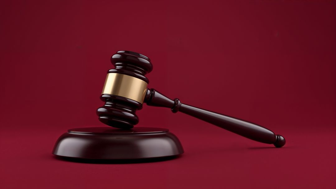 Judge's Gavel with Sound Block on Red Background