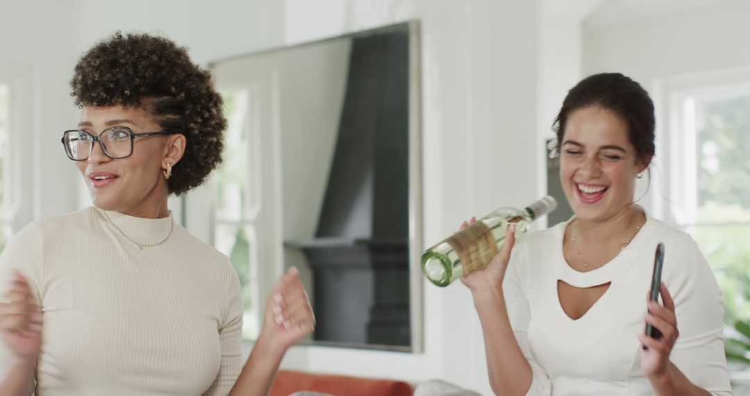 Friends Joyfully Celebrating with Drink in Hand at Home