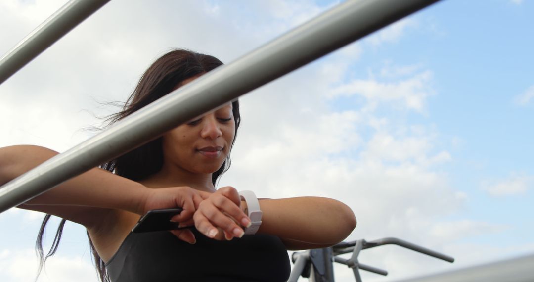 Woman Checking Smartwatch During Outdoor Exercise - Free Images, Stock Photos and Pictures on Pikwizard.com