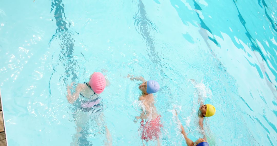 Children Swimming in Pool with Colorful Swim Caps Overhead View - Free Images, Stock Photos and Pictures on Pikwizard.com