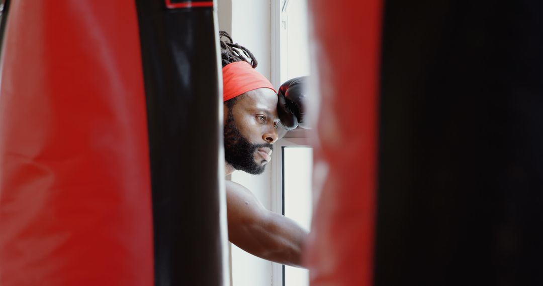 Contemplative Boxer Preparing in Gym Studio