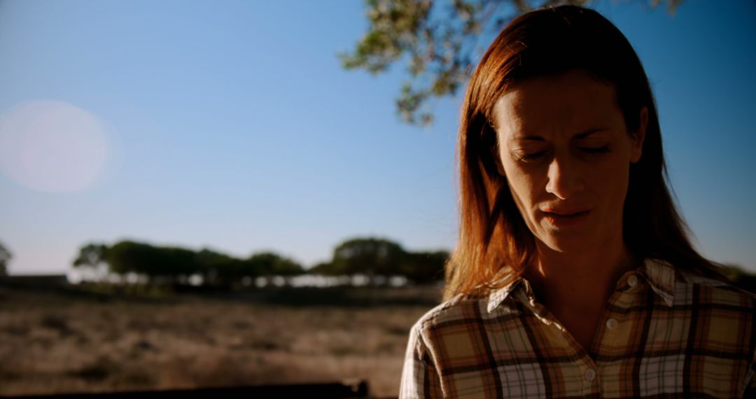 Woman in Plaid Shirt Reflecting Outdoors on Sunny Day - Free Images, Stock Photos and Pictures on Pikwizard.com