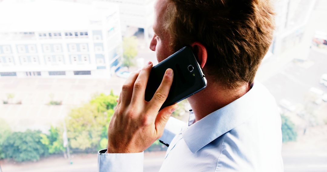 Businessman Having Important Phone Call in Office - Free Images, Stock Photos and Pictures on Pikwizard.com