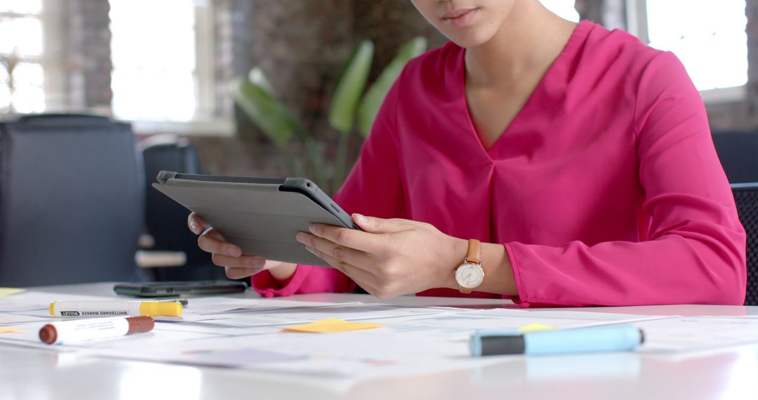 Businesswoman Reviewing Documents with Digital Tablet in Office - Free Images, Stock Photos and Pictures on Pikwizard.com