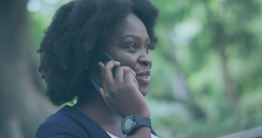 Woman Talking on Smartphone Outdoors Wearing Smartwatch