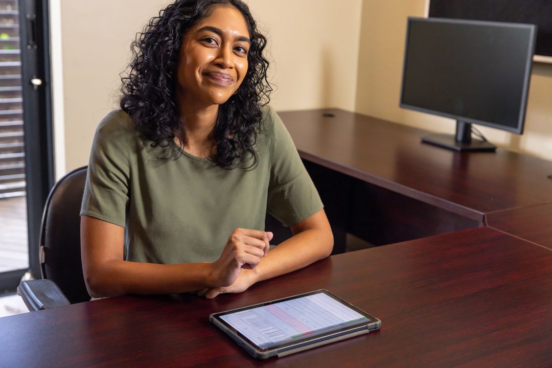 Confident Businesswoman Using Tablet at Office Desk for Work Productivity
