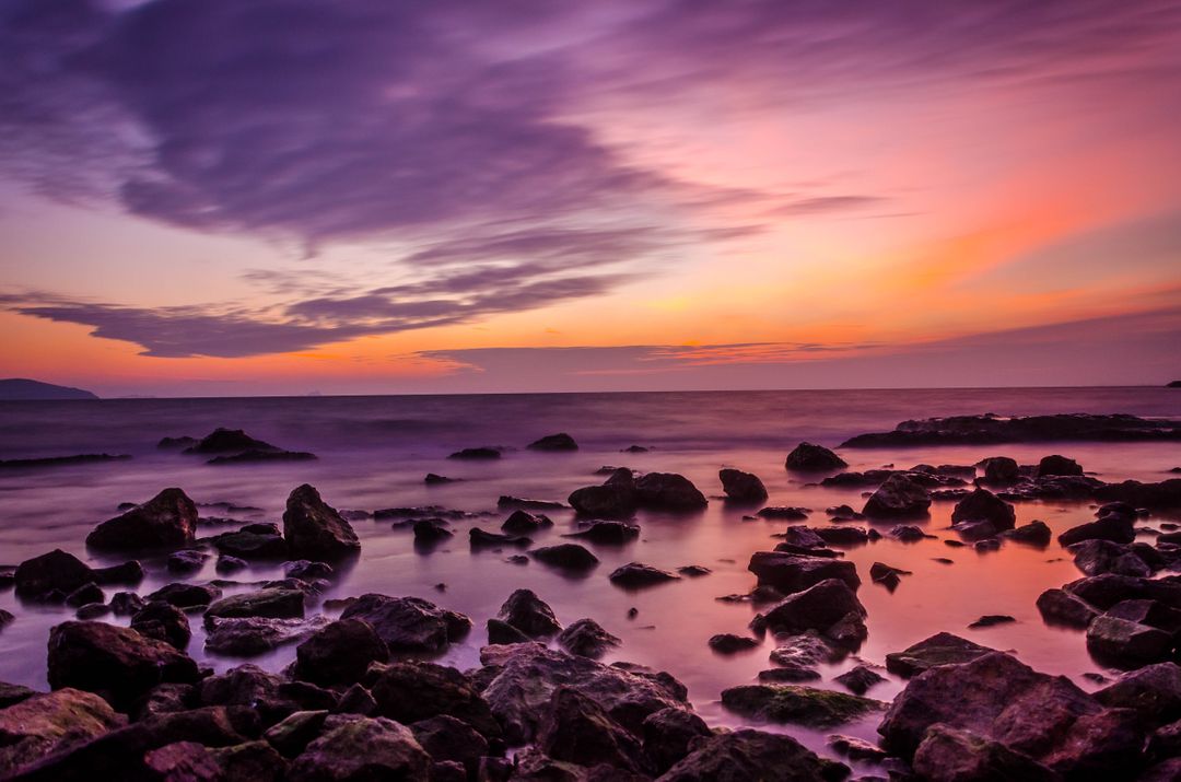 Tranquil Coastal Sunset with Vibrant Colors and Rocky Shoreline - Free Images, Stock Photos and Pictures on Pikwizard.com