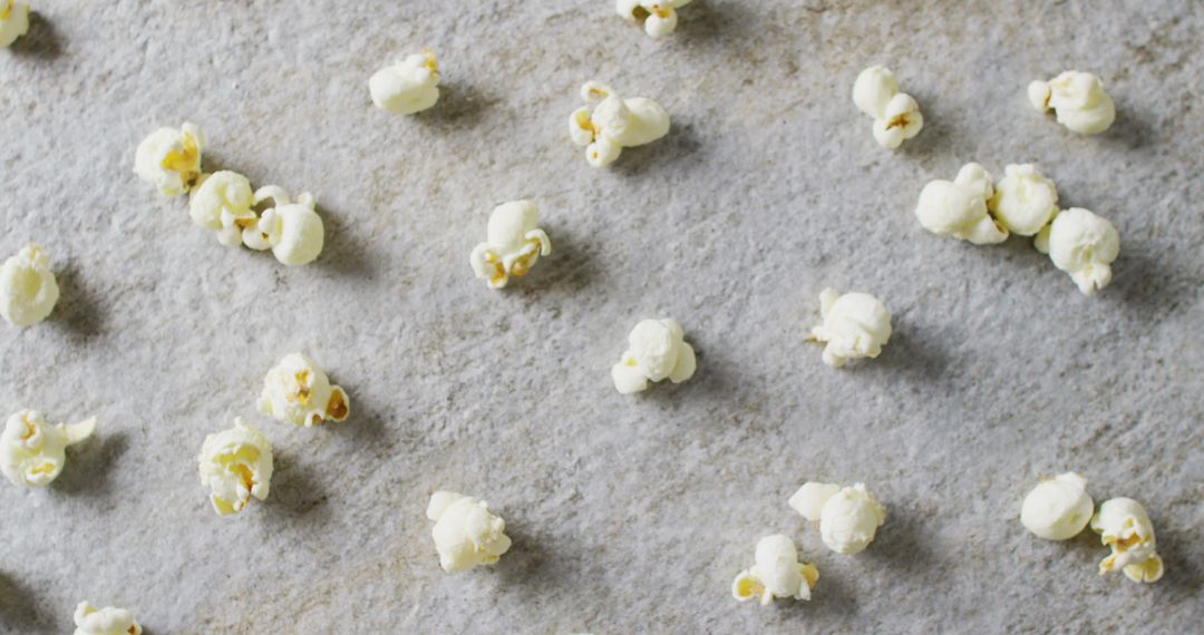 Close-Up of Scattered Popcorn on Gray Surface