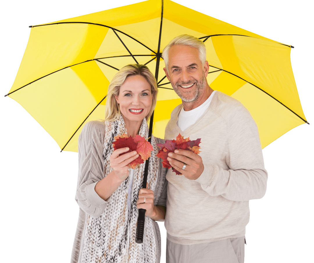 Smiling Couple Holding Leaves Under Transparent Yellow Umbrella