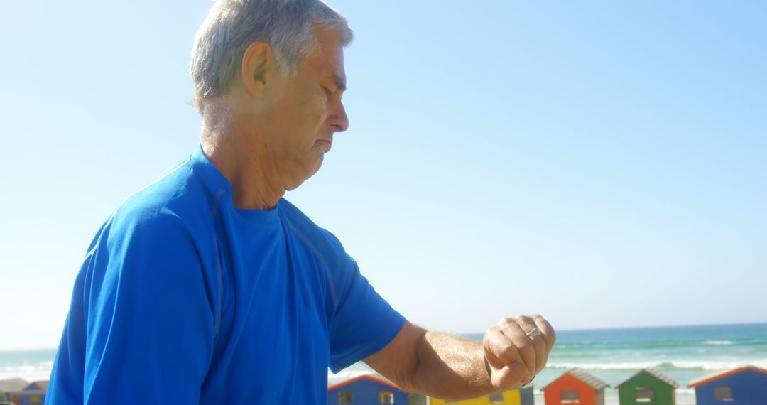Senior Man Checking Smartwatch by the Beach