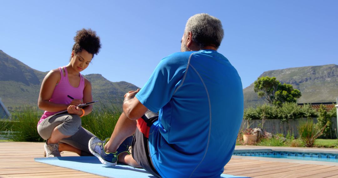 Personal Trainer with Senior Man Exercising by Outdoor Pool - Free Images, Stock Photos and Pictures on Pikwizard.com