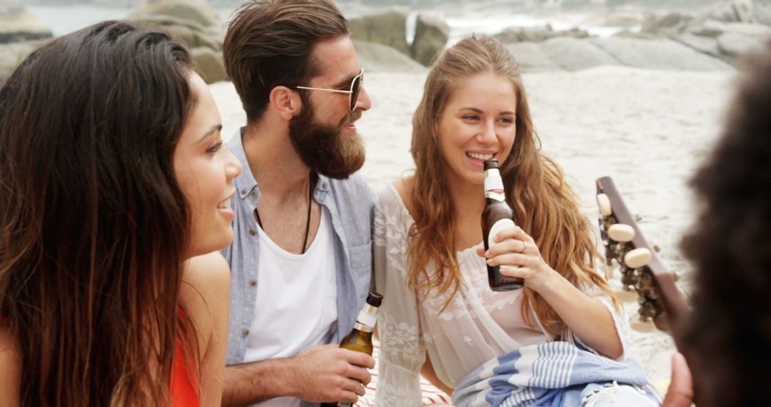 Friends Enjoying Beach Gathering with Drinks