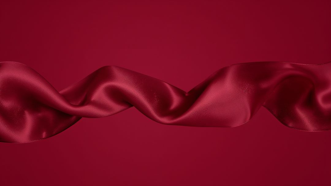 Elegant Fluid Red Satin Ribbon Creating Dynamic S-Shaped Wave