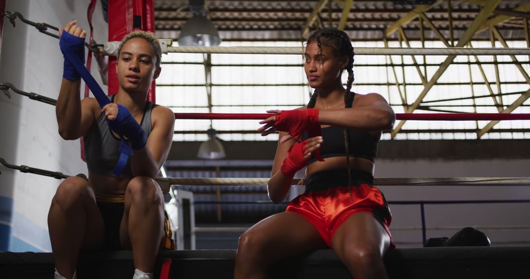 Female Athletes Wrapping Hands in Boxing Gym - Free Images, Stock Photos and Pictures on Pikwizard.com