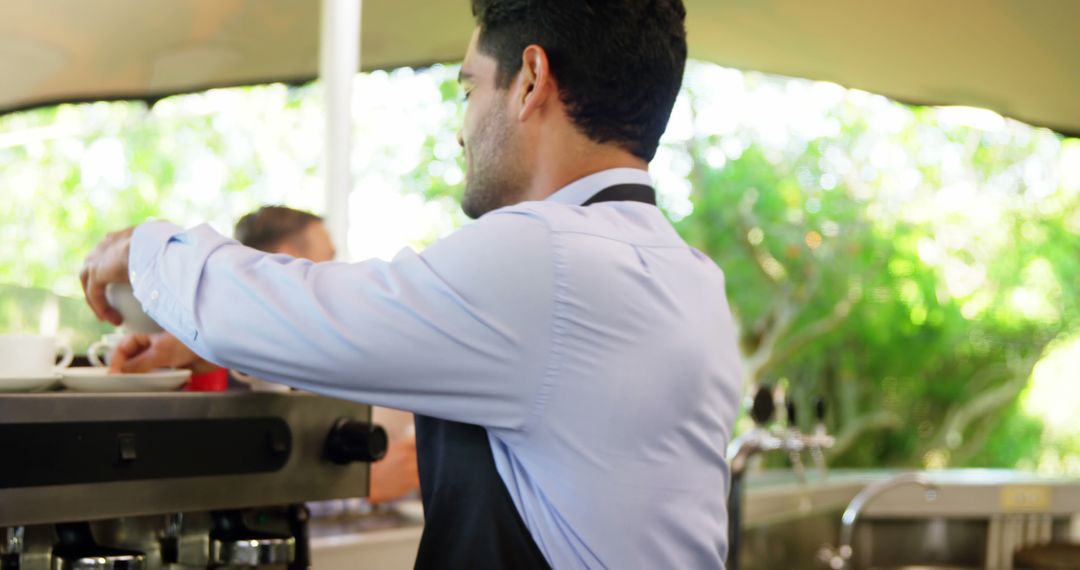 Waiter Serving Coffee at Sunny Outdoor Café