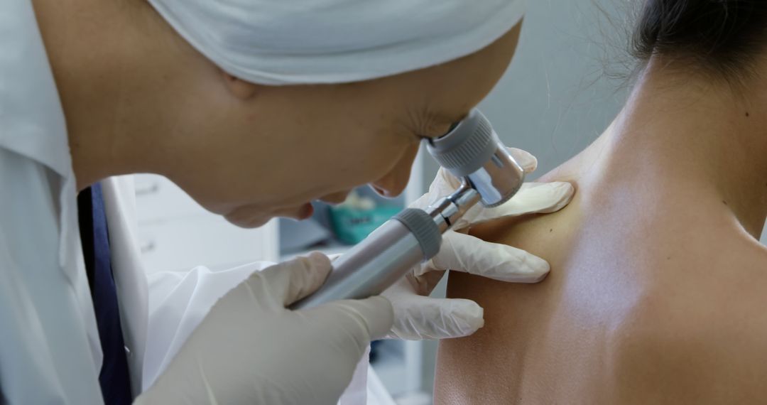 Dermatologist Examining Woman Skin with Dermatoscope in Clinic - Free Images, Stock Photos and Pictures on Pikwizard.com