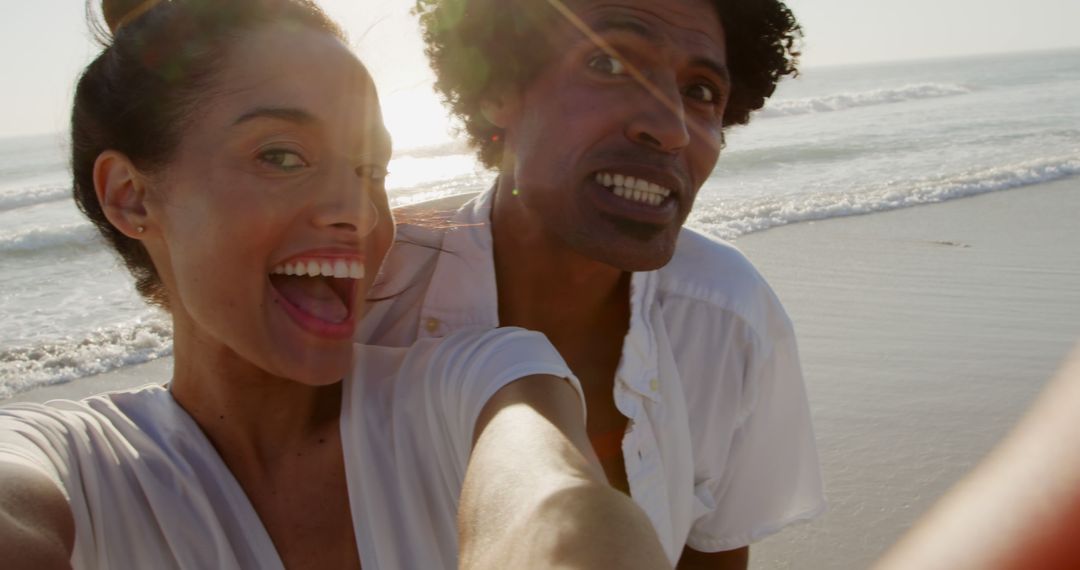 Cheerful Couple Taking Selfie on Beach at Sunset - Free Images, Stock Photos and Pictures on Pikwizard.com