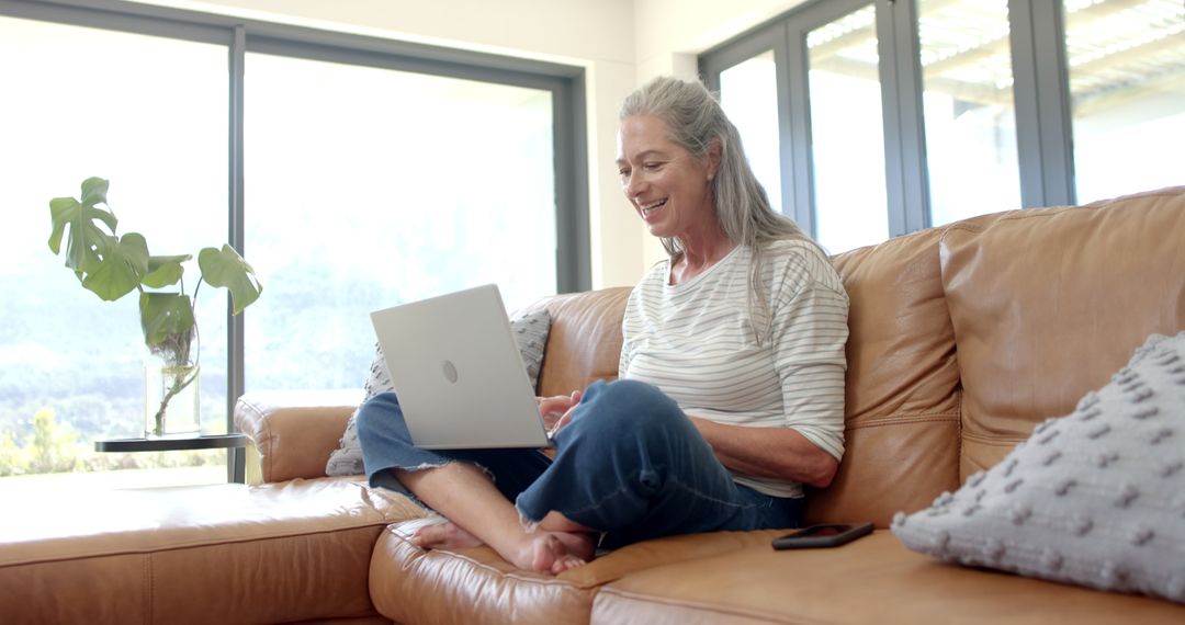 Senior Woman Enjoying Laptop Time at Home in Casual Setting