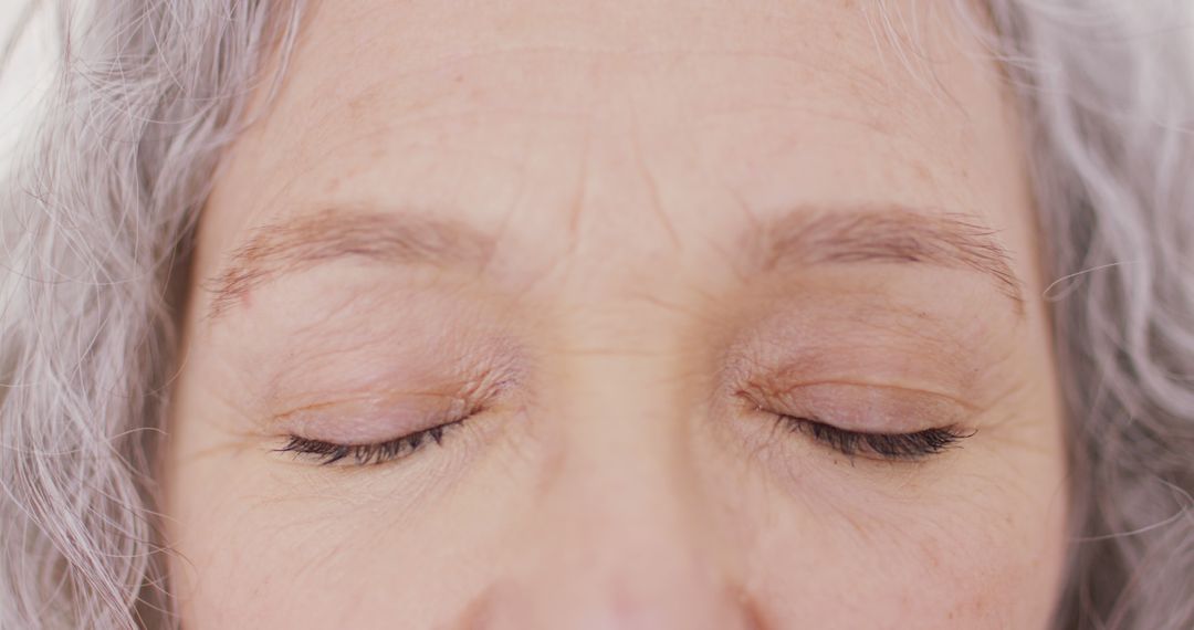 Closeup of Senior Woman with Closed Eyes and Gray Hair - Free Images, Stock Photos and Pictures on Pikwizard.com