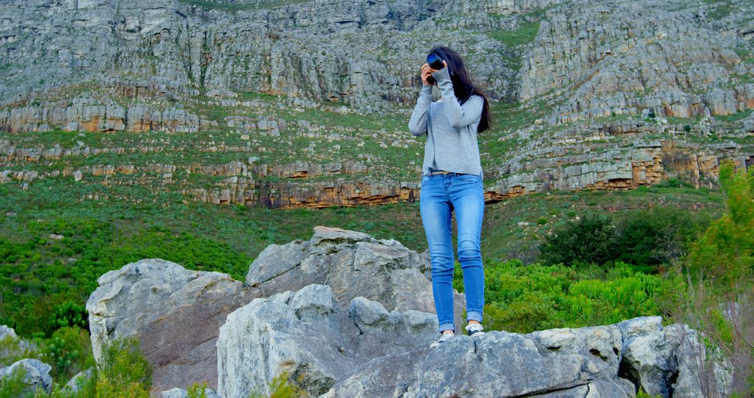 Woman Using Camera to Explore Rocky Landscape - Free Images, Stock Photos and Pictures on Pikwizard.com