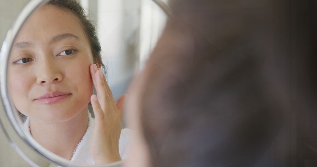 Woman Applying Skincare in Bathroom Mirror - Free Images, Stock Photos and Pictures on Pikwizard.com