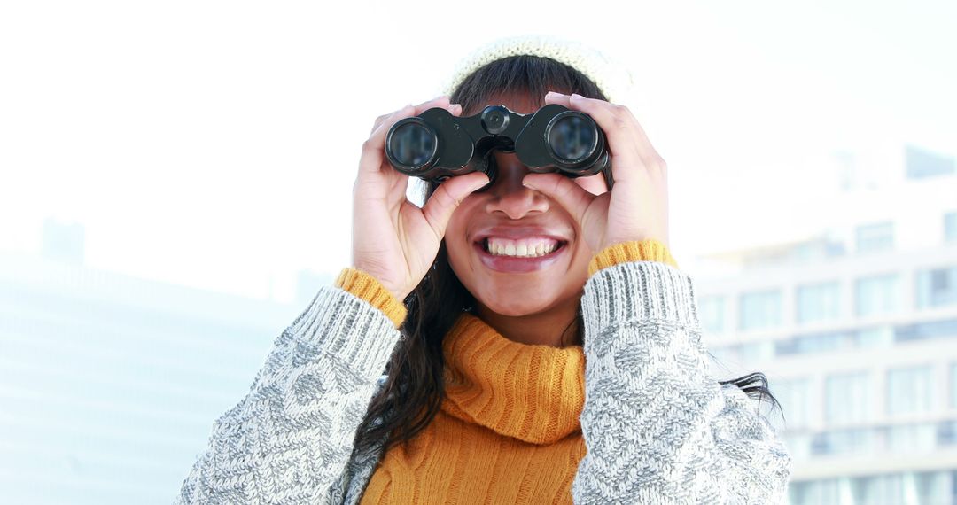 Woman Wearing Knit Clothes Using Binoculars Outdoors - Free Images, Stock Photos and Pictures on Pikwizard.com