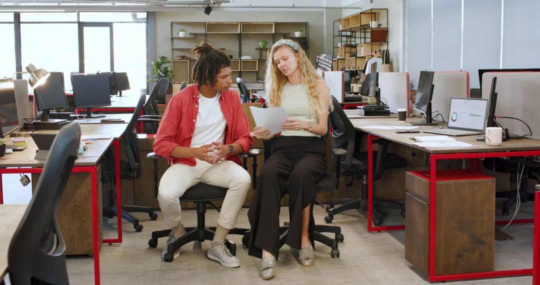 Multiracial Colleagues Analyzing Documentation in Modern Office Setting