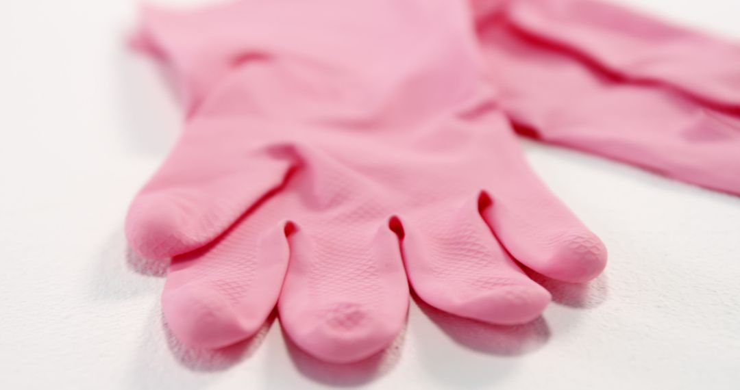 Close-up of pink gloves against white background - Free Images, Stock Photos and Pictures on Pikwizard.com