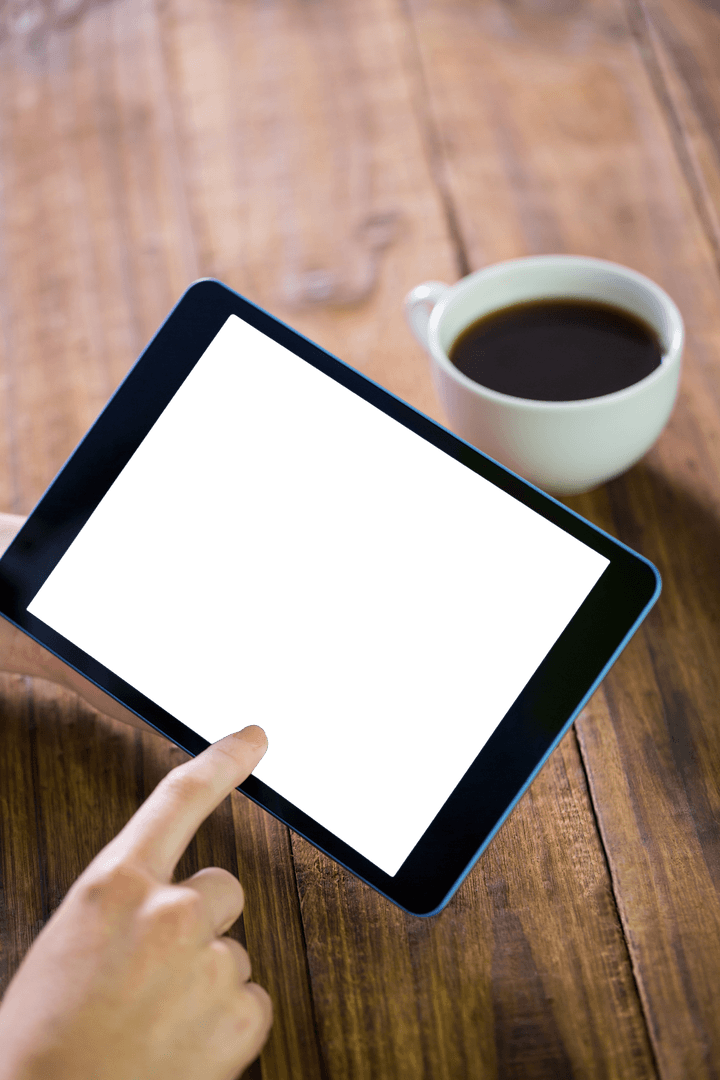 Tablet With Transparent Screen and Coffee on Wooden Table