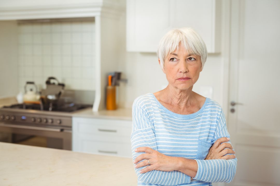 Senior Woman in Modern Kitchen with Thoughtful Expression