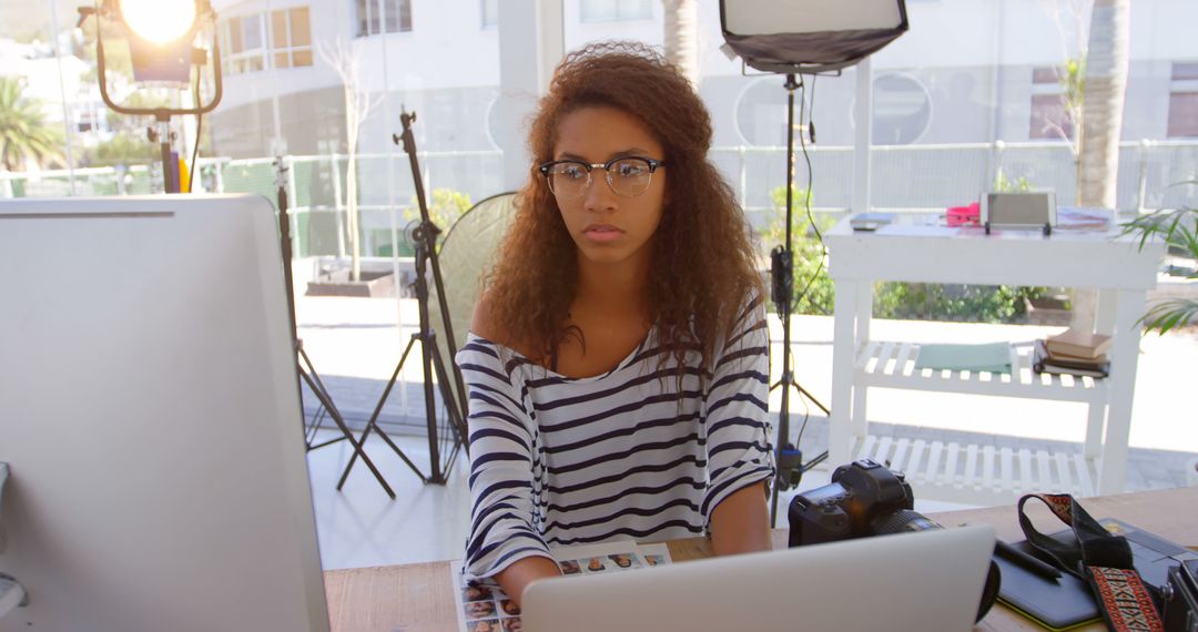 Afro-American Woman in Glasses Working on Desktop Computer in Modern Office - Free Images, Stock Photos and Pictures on Pikwizard.com