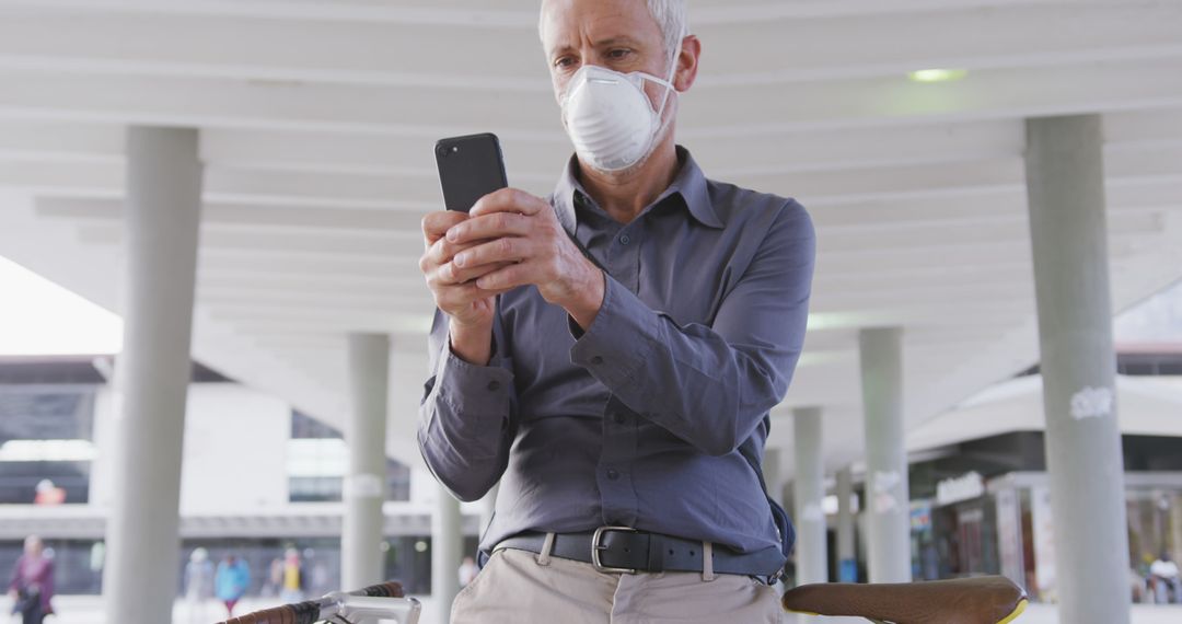 Older Man Wearing Face Mask Using Smartphone Outdoors - Free Images, Stock Photos and Pictures on Pikwizard.com