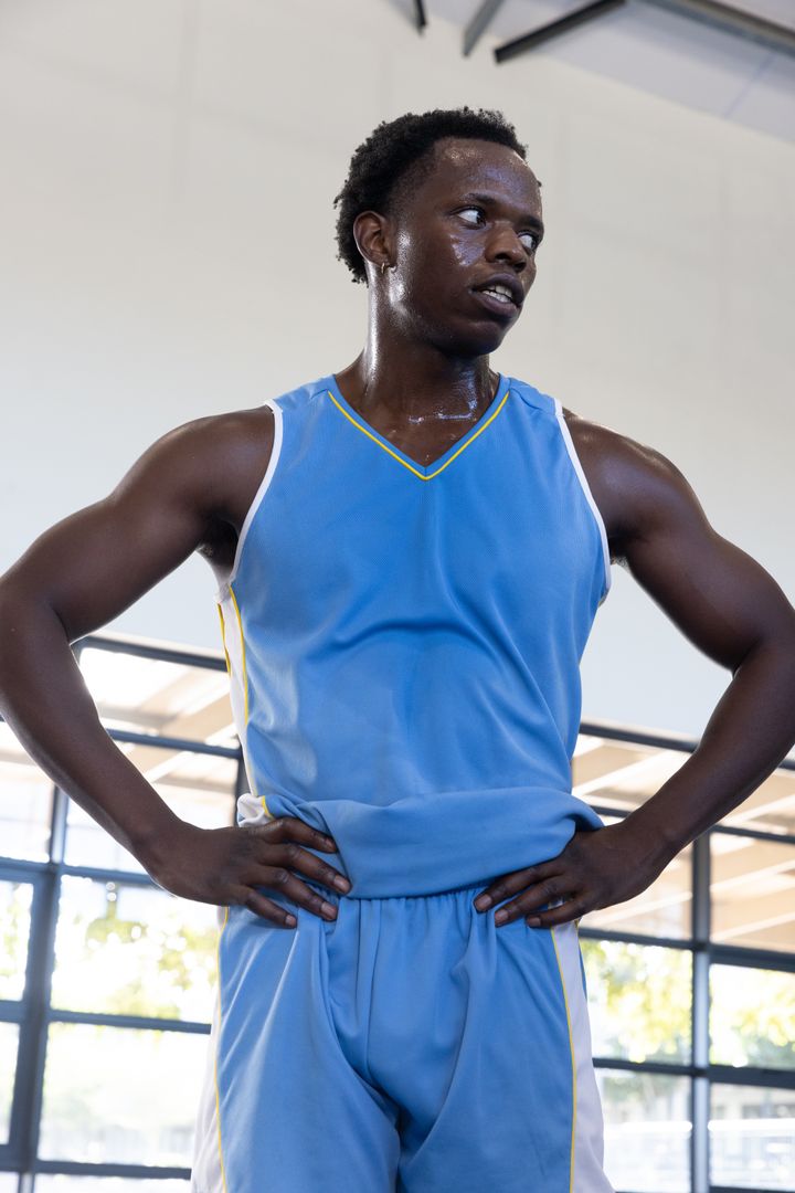 Hydrated Athlete Resting with Determination in Gym