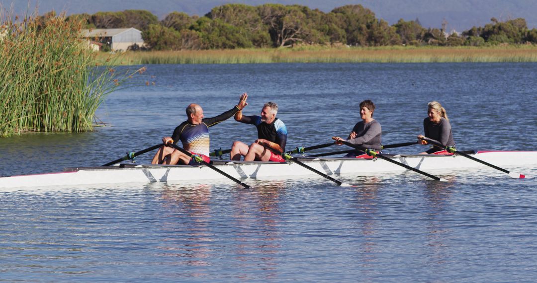 Team Rowing on Calm Lake, Celebrating Success - Free Images, Stock Photos and Pictures on Pikwizard.com