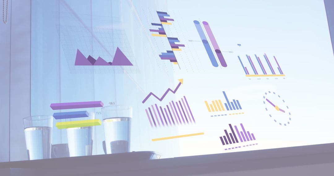 Business Analytics Displayed Over Work Desk with Glasses of Water