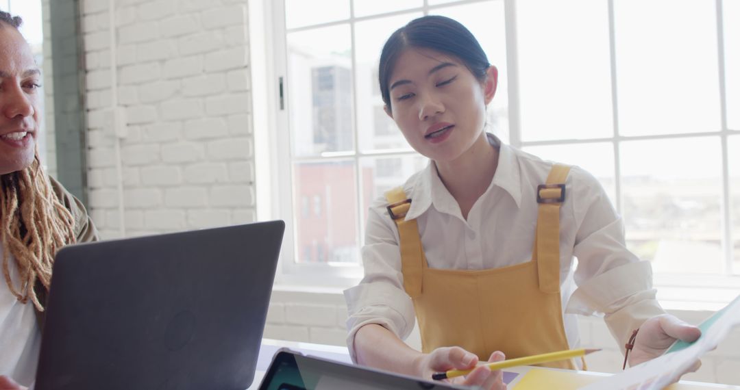 Diverse Team Collaborating Over Business Project in Bright Office