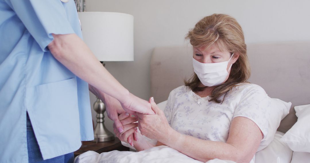 Nurse Comforting Female Patient with Face Mask in Hospital Bed - Free Images, Stock Photos and Pictures on Pikwizard.com